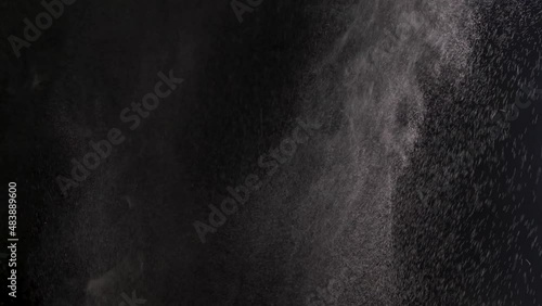 Slow motion. Spraying water droplets. Water spray nozzle. Water vapor jet from the humidifier. White smoke isolated on black background with visible droplets. Isolated