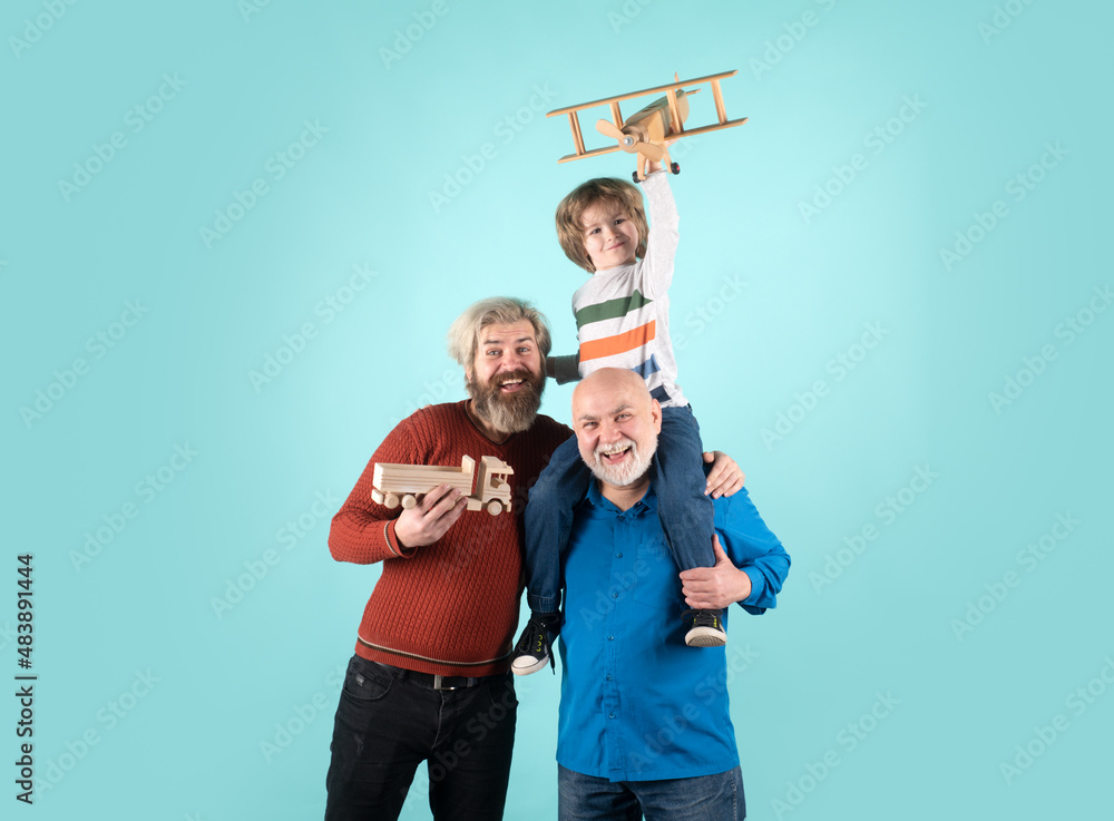 Fototapeta premium Grandfather father and grandson playing with toy plane. Boy dreams of becoming a pilot.