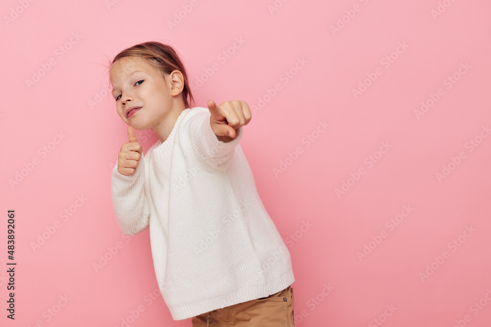 Portrait of happy smiling child girl white sweater posing fun isolated background Portrait of happy smiling child girl white sweater posing fun isolated background