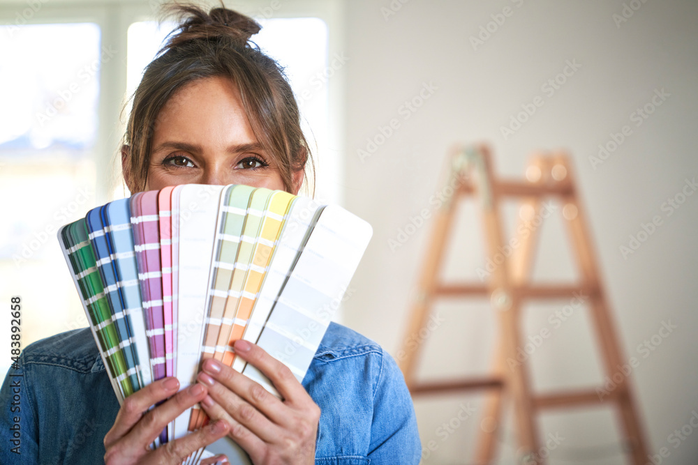 Close up portrait of caucasian woman hiding behind a color swatch Close up portrait of caucasian woman hiding behind a color swatch