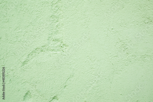 Green textured plastered wall, background, texture wallpaper.