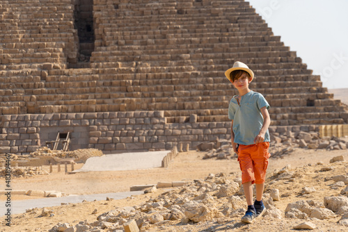 Boy walking in front of the pyramid of Mikerin on the Giza plateau.