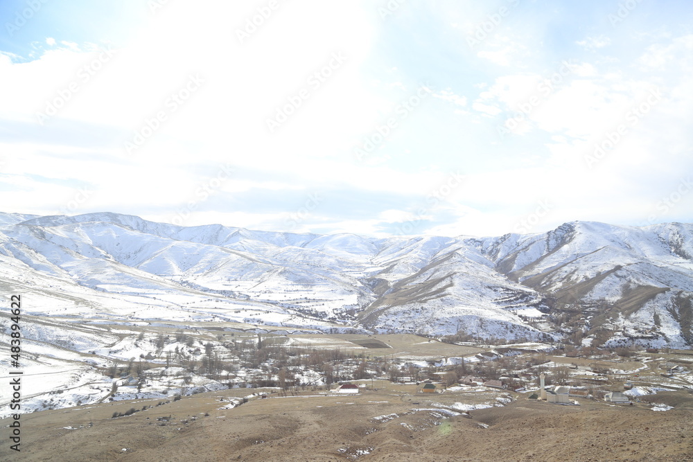 Traveler hiking in mountains clouds landscape