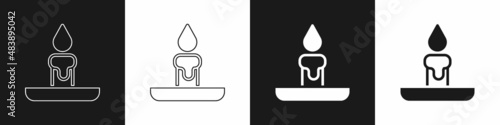 Set Burning candle in candlestick icon isolated on black and white background. Cylindrical candle stick with burning flame. Vector
