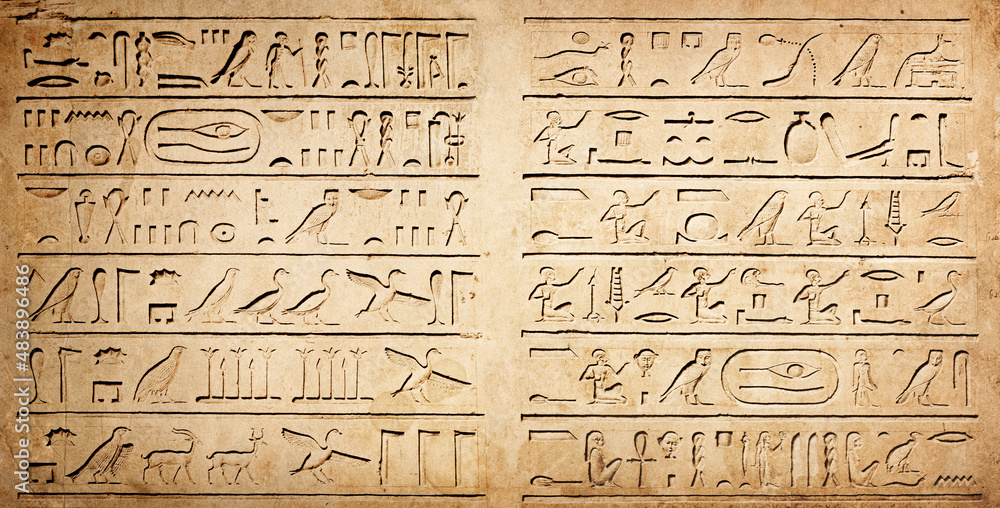 Old Egyptian hieroglyphs on an ancient background. Wide historical background. Ancient Egyptian hieroglyphs as a symbol of the history of the Earth. Old Egyptian hieroglyphs on an ancient background. Wide historical background. Ancient Egyptian hieroglyphs as a symbol of the history of the Earth.