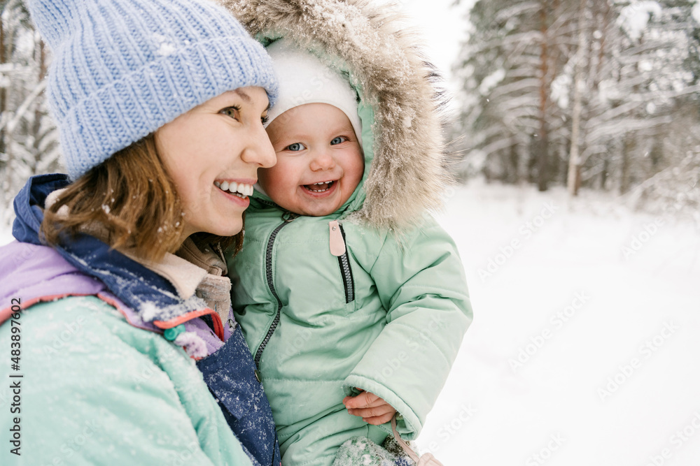 Contemplative woman with cute daughter in winter Contemplative woman with cute daughter in winter