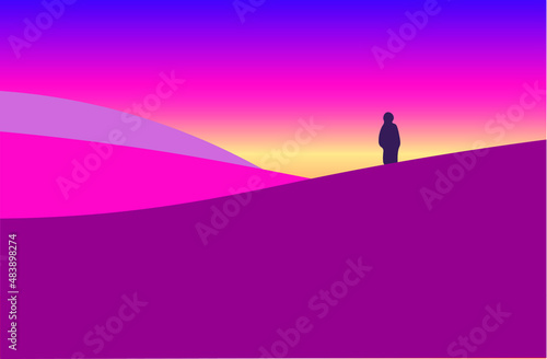 Silhouette of a person standing on hill during sunrise. © NoorRadya