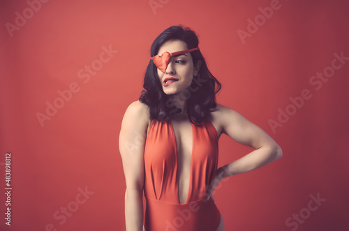 Tela Beautiful woman dressing in red with heart shaped eye patch