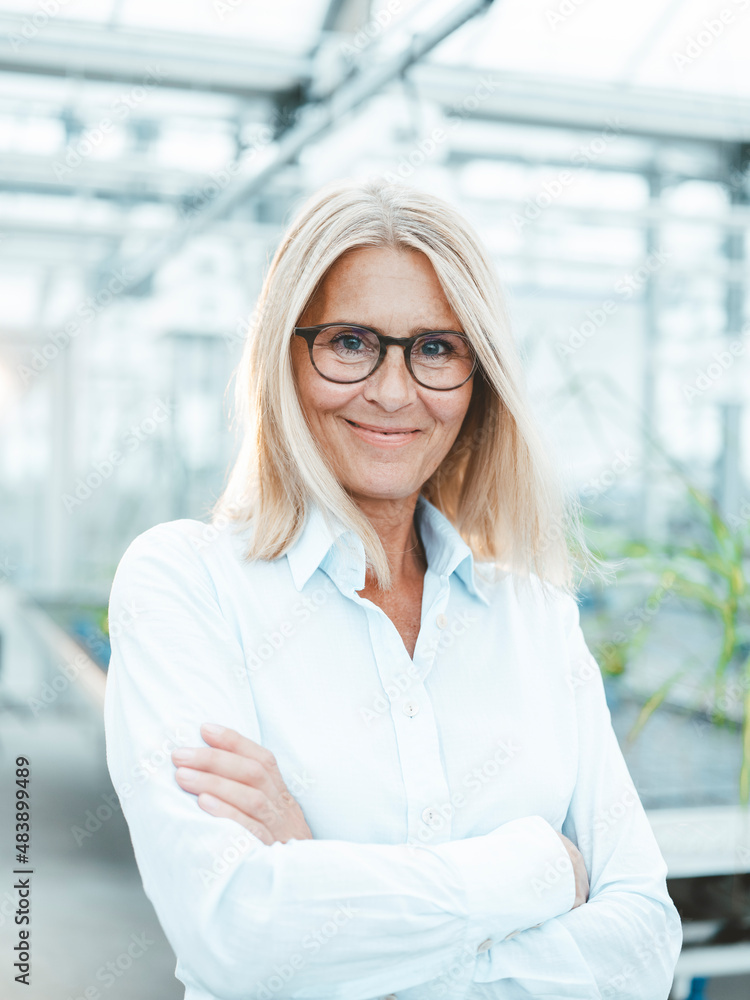 Agronomist wearing eyeglasses in greenhouse Agronomist wearing eyeglasses in greenhouse