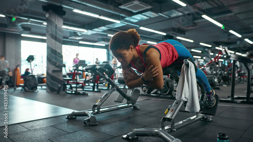 Black girl doing sport exercise for lumbar in gym