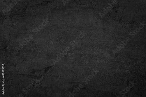 Close up retro plain dark black cement & concrete wall background texture © Phokin