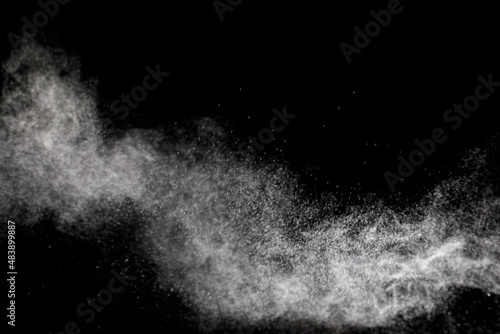 Abstract splashes of water on black background. Freeze motion of white particles. Rain, wind and snow overlay texture.