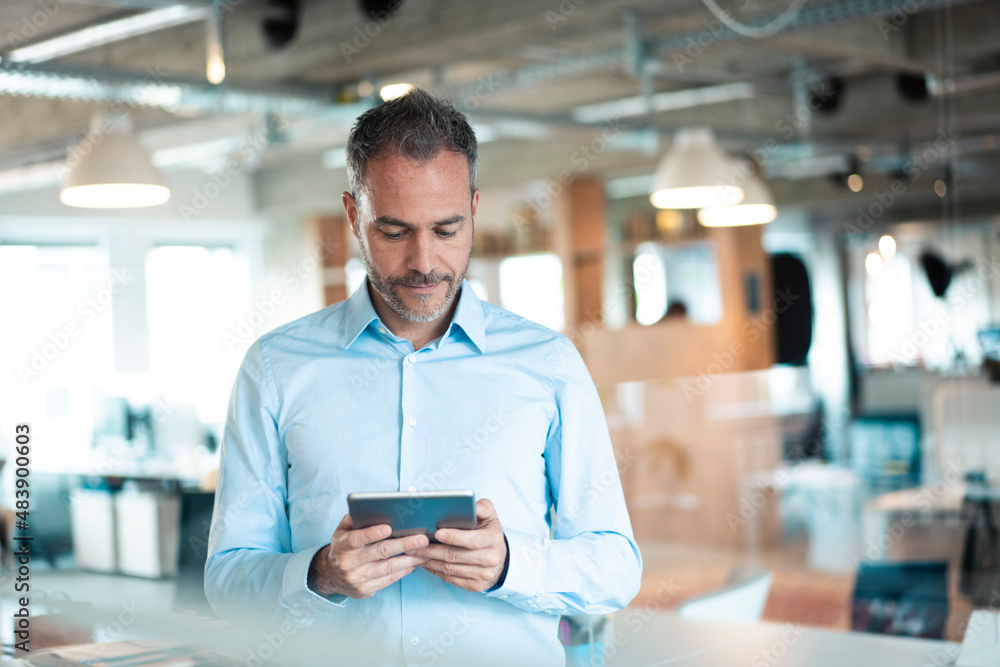 Dedicated working man using tablet computer at workplace Dedicated working man using tablet computer at workplace