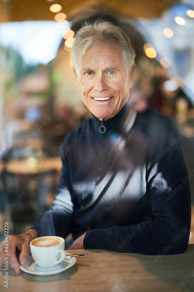 Smiling senior man with coffee cup in cafe Smiling senior man with coffee cup in cafe