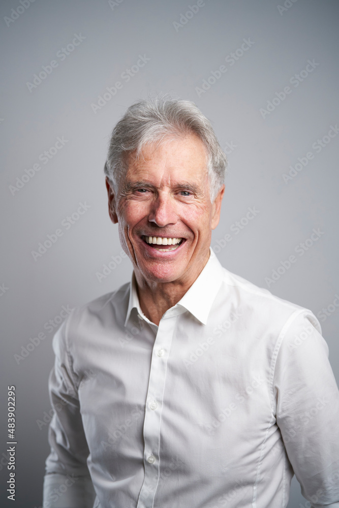 Senior businessman laughing in studio Senior businessman laughing in studio