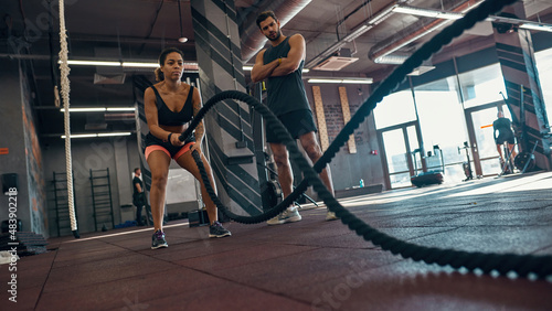 Bottom of man looking at girl exercise with s rope