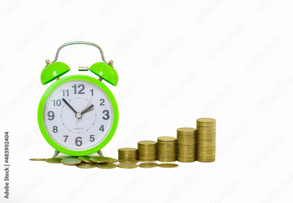 Stack of increasing coins with green alarm clock. Stack of increasing coins with green alarm clock.