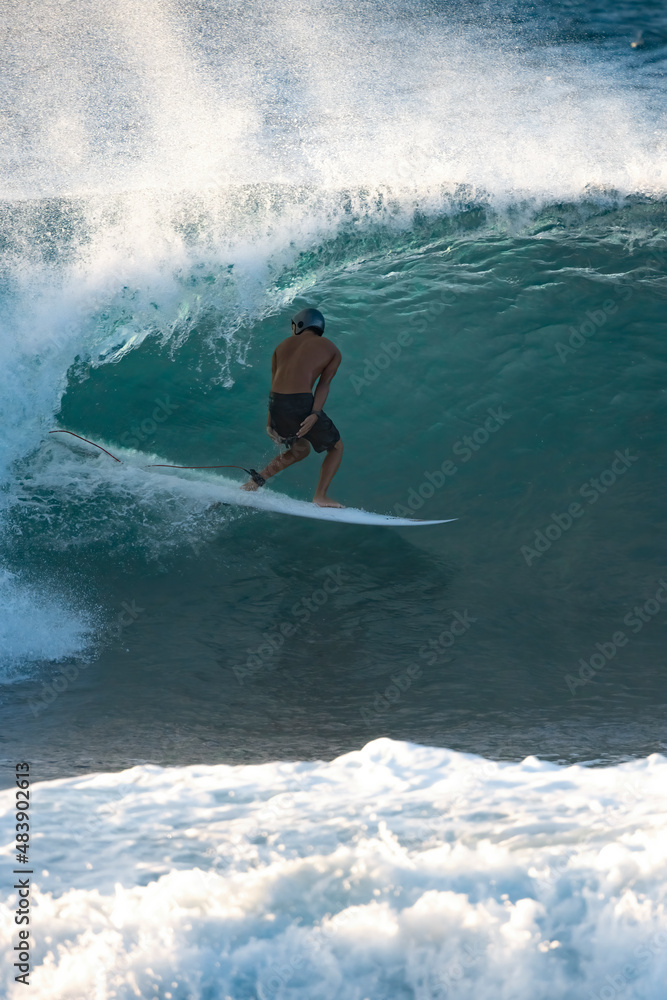 Surfer riding a barrel wave on a short board
