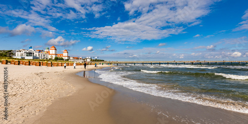 Germany, Mecklenburg-Vorpommern, Binz, Sandy beach of Rugen island with pier and Kurhaus Binz in background photo