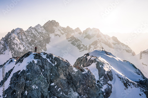 Climber standing on Vorderer Tajakopf mountain, Ehrwald, Tirol, Austria photo