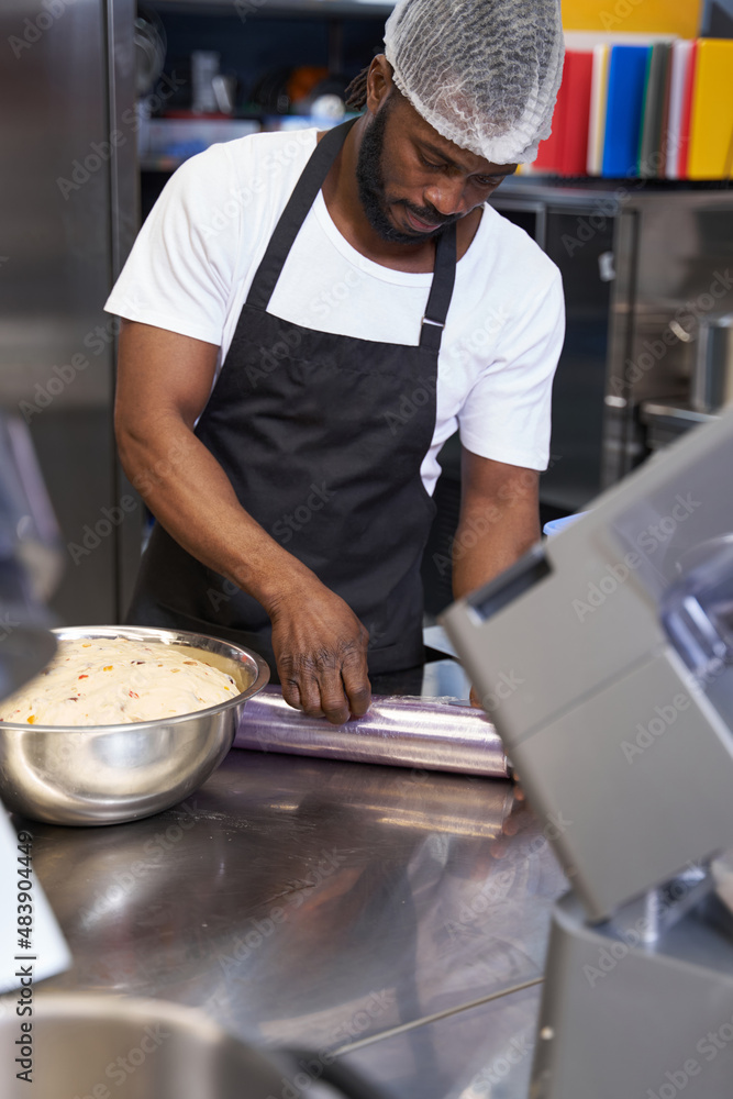 Man in black apron preparing ingredients in the kitchen Man in black apron preparing ingredients in the kitchen