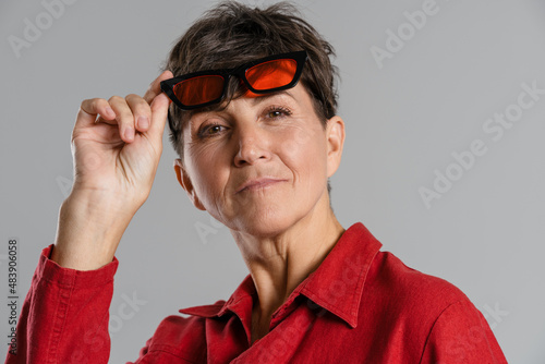 Mature european woman wearing sunglasses looking at camera