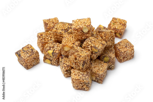 Heap of Turkish delight., lokum, with sesame seed and pistachio nuts close up isolated on white background 