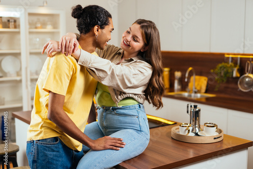 modern multiethnic unstereotyped couple lifestyle moments at home. Not stereotyped boyfriend and girlfriend living together. True love concepts photo