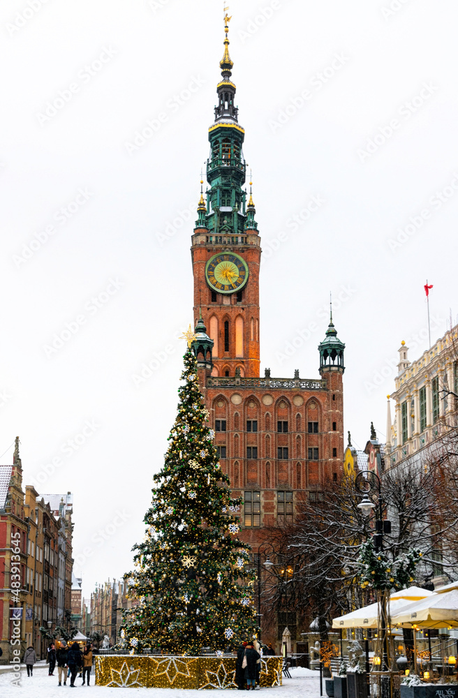 City Hall in Gdansk and winter snow-covered historic street