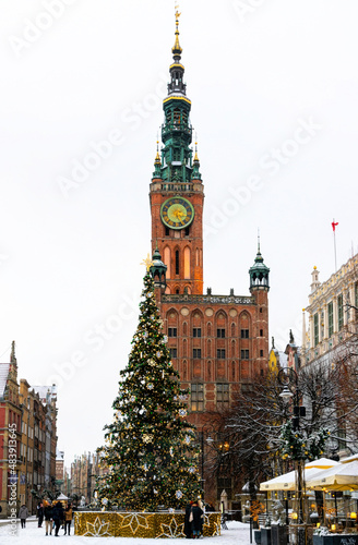 City Hall in Gdansk and winter snow-covered historic street