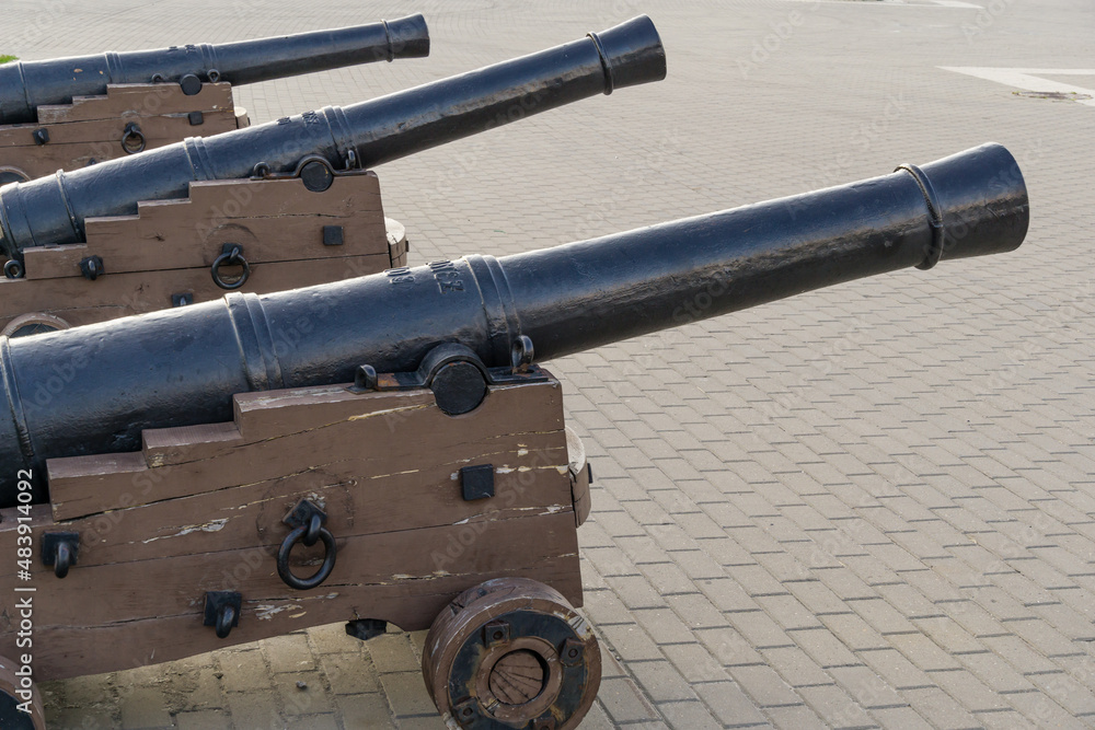 Black iron replica cannons from battleship Goto Predestination on Admiralteyskaya Square in Voronezh. Guns on gun carriage close-up.