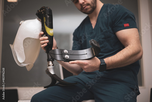 an orthopedist fixing a prosthetic leg for an athlete.bionic leg. photo