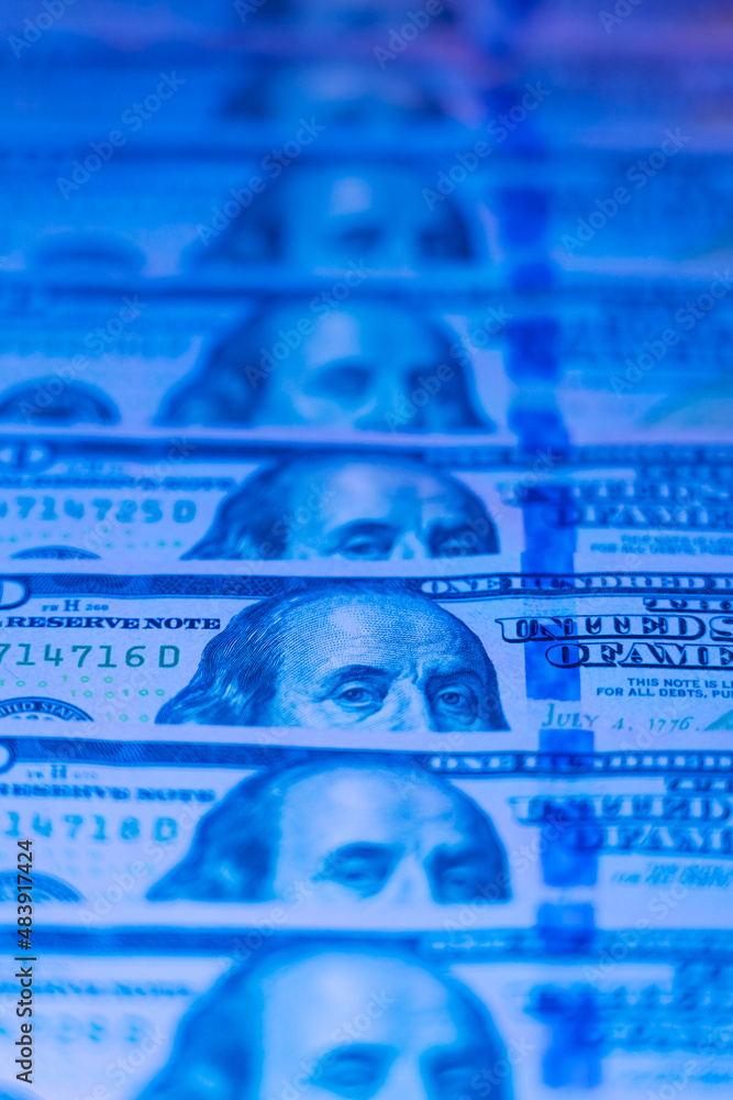Fototapeta premium Money background. Dollars. Finance and wealth in blue neon light