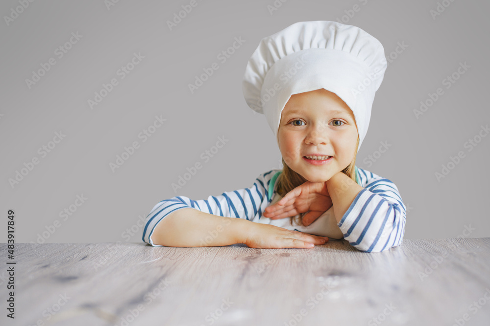 happy cute little kid girl wear chef uniform and cooking a birthday cake happy cute little kid girl wear chef uniform and cooking a birthday cake