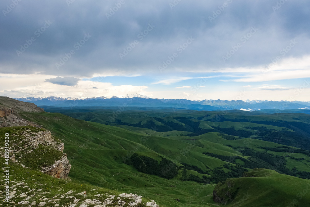 View of Elbrus and the Bermamyt plateau in the Karachay-Cherkess Republic, Russia. The Caucasus Mountains. View of Elbrus and the Bermamyt plateau in the Karachay-Cherkess Republic, Russia. The Caucasus Mountains.