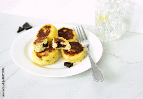 Syrniki, cottage cheese fritters with chocolate, minimalist style