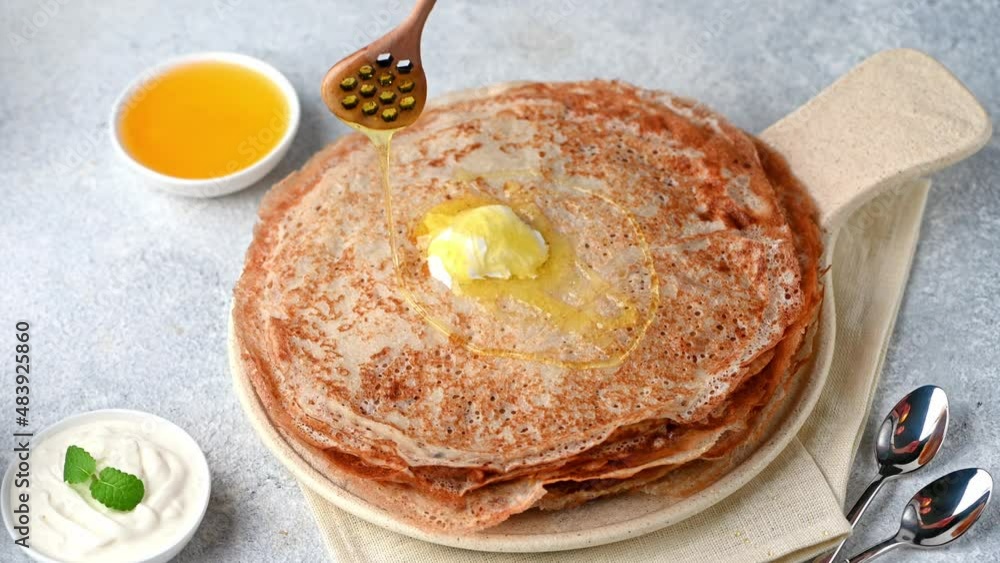 Pancakes with maple syrup. Pouring syrup on pancakes. Pouring honey on crepes. Maslenitsa blini. Shrovetide holiday. Shrove tuesday. Pancake day. Pancakes with maple syrup. Pouring syrup on pancakes. Pouring honey on crepes. Maslenitsa blini. Shrovetide holiday. Shrove tuesday. Pancake day.