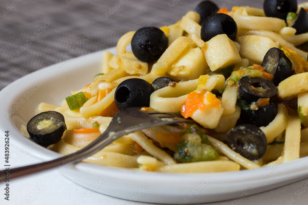 Pasta with cuttlefish, black olives, celery and carrots. Pasta format called scialatielli. A good and tasty pasta dish Pasta with cuttlefish, black olives, celery and carrots. Pasta format called scialatielli. A good and tasty pasta dish