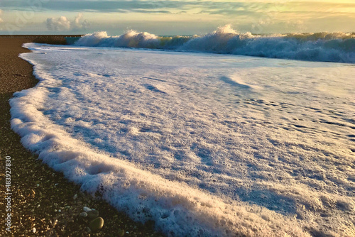 Beautiful wave texture on the seashore. Exotic island seaside banner with place for text. Dramatic colours photo. Sea waves with a lot of sea foam. Natural background for concept summer vacation. Natu