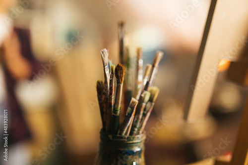 Close up of jar full of paintbrushes 