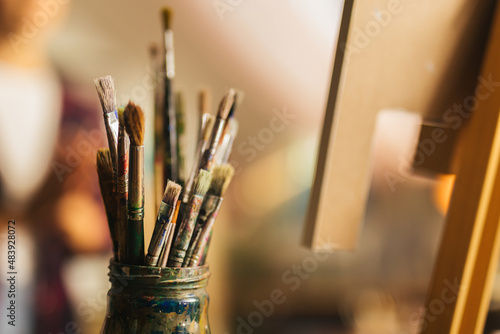 Close up of jar full of paintbrushes 