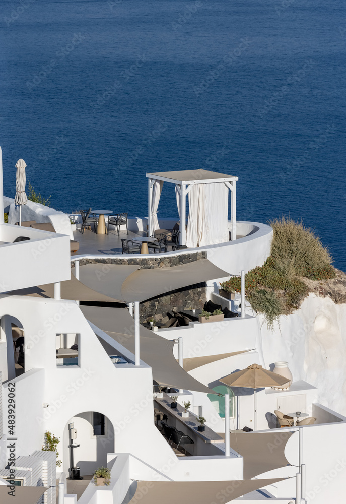  Whitewashed houses with terraces and pools and a beautiful view in Oia on Santorini island, Greece