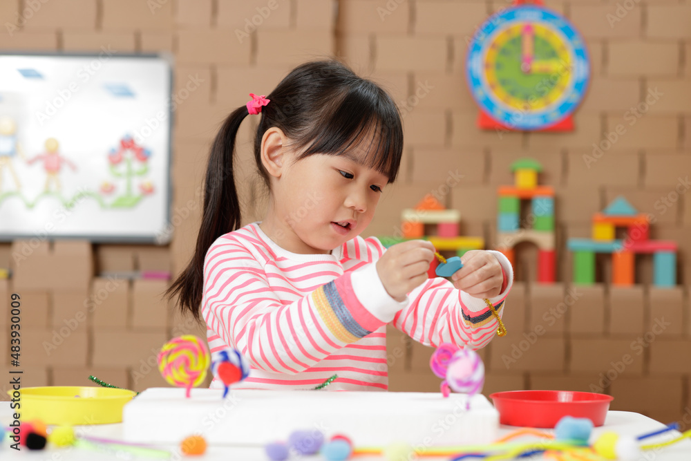 young girl making bead craft at home young girl making bead craft at home