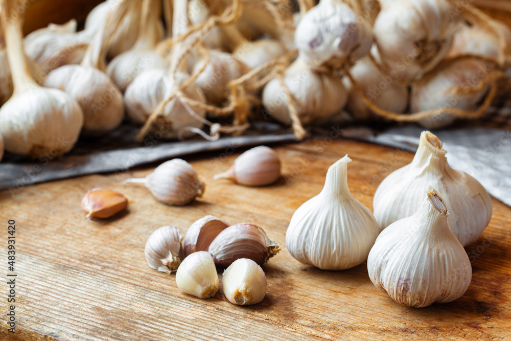 Homegrown garlic bulb on rustic wooden table Homegrown garlic bulb on rustic wooden table