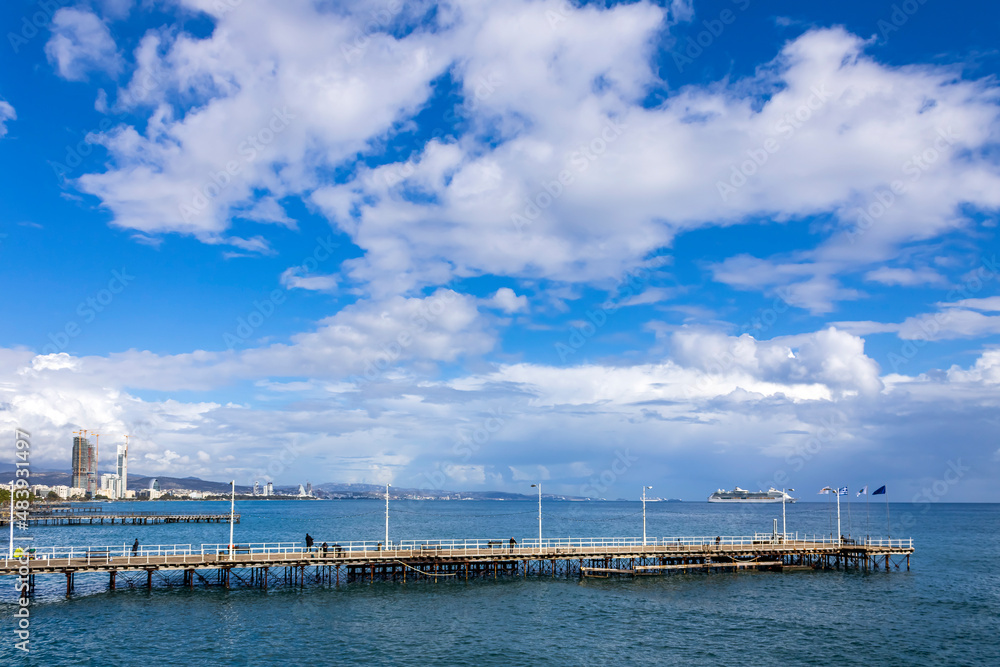 Blue sky with gray clouds above sea piers, Limassol, Cyprus 