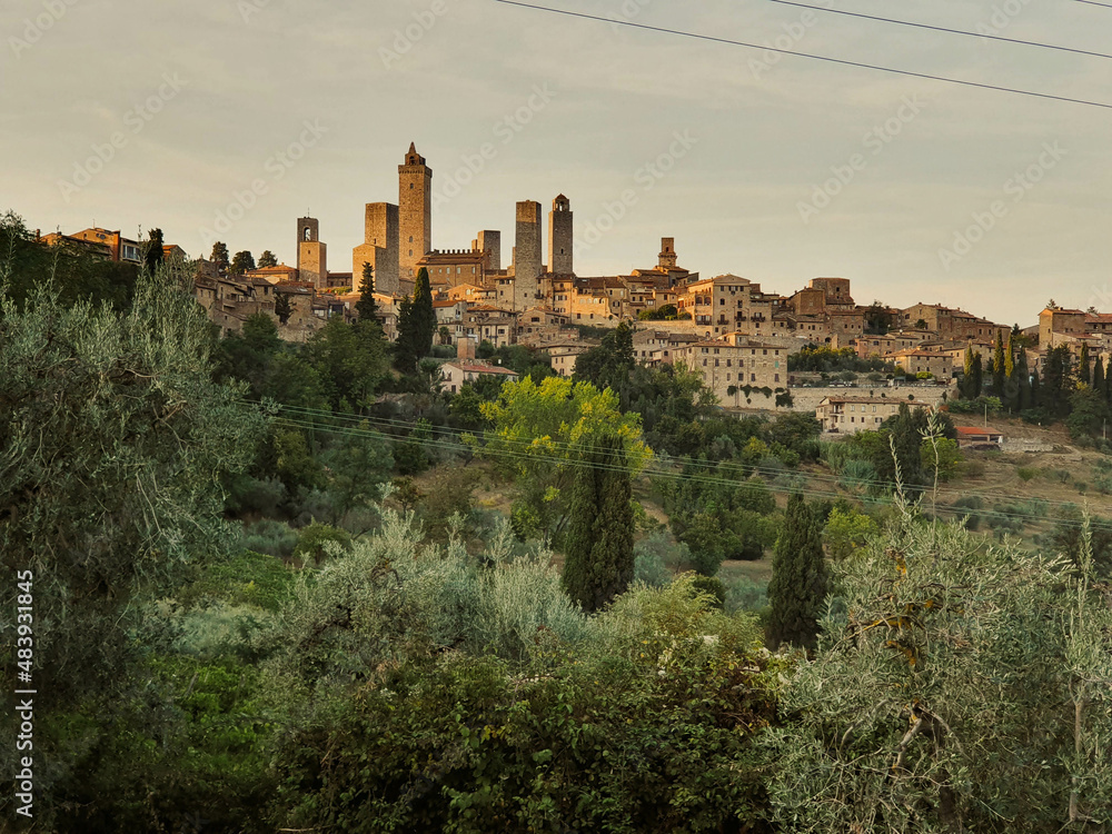 Typical Tuscany old city with beautiful stone towers in golden hour sunlight, Italy