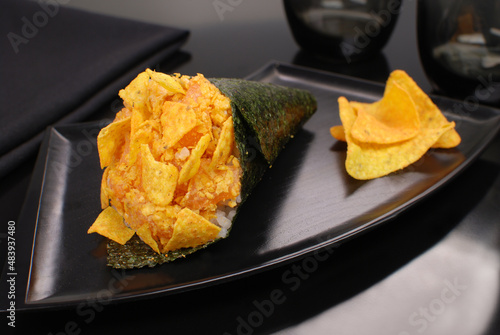 Doritos and Salmon fish Temaki in black background