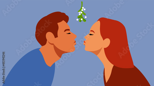 Kissing under mistletoe branch. The guy and the girl are kissing. A gentle first kiss. Relations, love, date, love, affection, teens.
