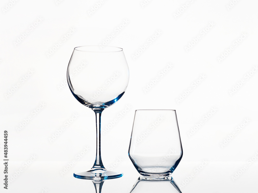 Empty wine glasses on a white background. beautiful still life Empty wine glasses on a white background. beautiful still life