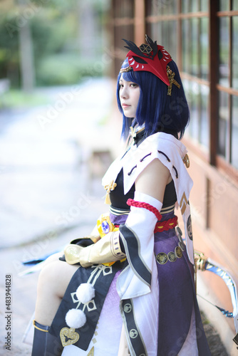 Japanese young woman hunter cosplay with bow on Japanese garden